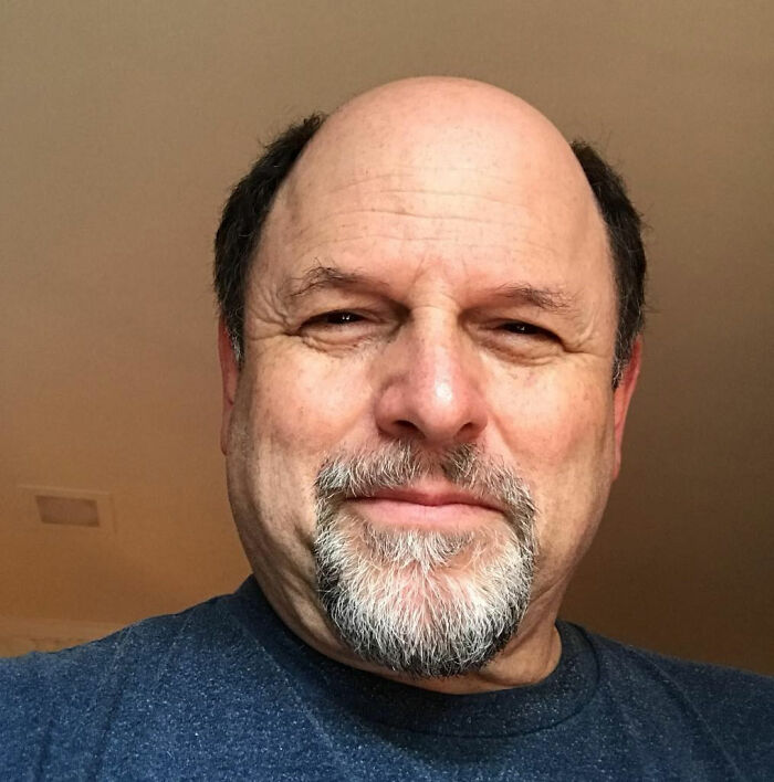 A man with a goatee and a blue shirt, the Seinfeld star, in a close-up shot. A man with a goatee and a blue shirt, the Seinfeld star, in a close-up shot.