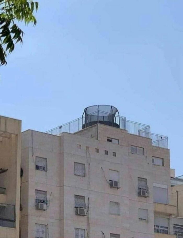 A trampoline on the roof of a building, a ridiculous example of America's cultural decline.
