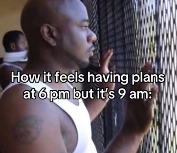 A man looking out a window, feeling the slow wait for 6 pm plans at 9 am, a relatable meme to boost morale.