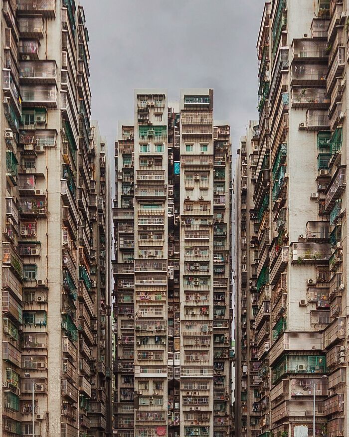 A photographer captures a perfectly composed image of towering, closely-packed architectural locations.