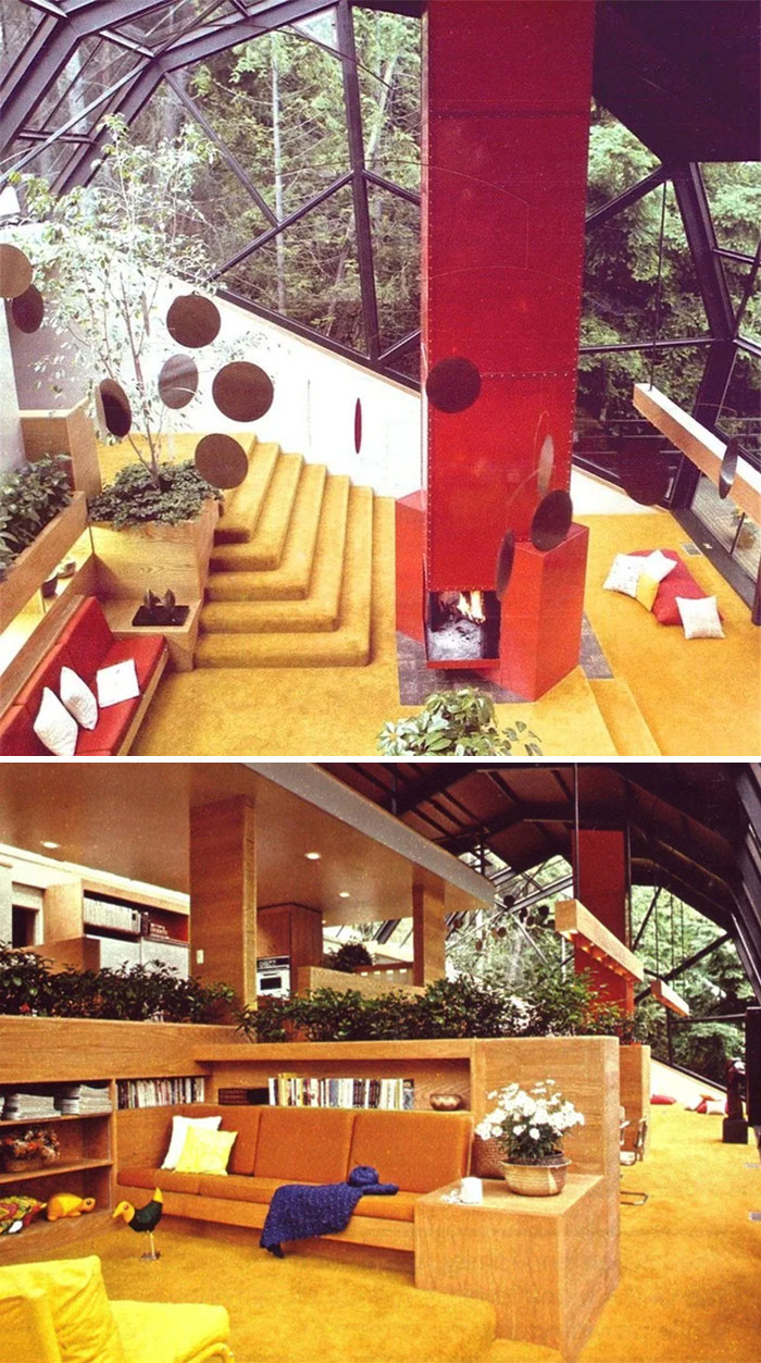 Multi-level living space with yellow carpet, a red fireplace, and ample natural light, capturing the essence of 1970s and 1980s interior design.