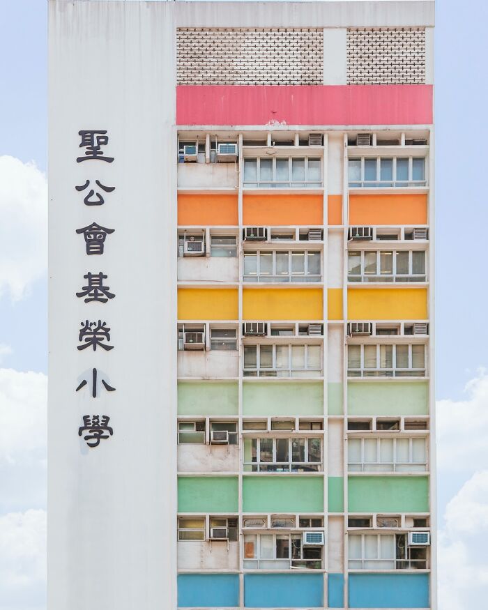A tall, colorful architectural location with orange, yellow, and green sections and Chinese characters on its side.