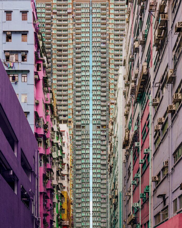 Architectural locations: two tall, densely packed buildings with colorful facades, creating a narrow alley effect.