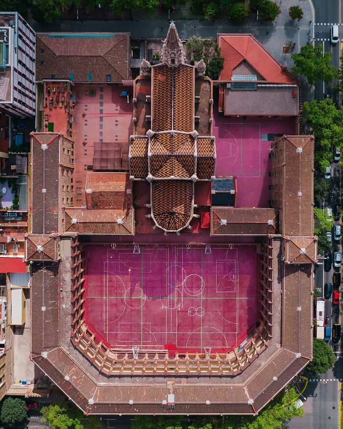 Aerial view of a historic architectural building with a central church-like structure and multiple courtyards, showcasing architectural locations.