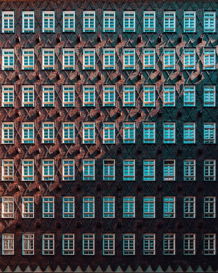 A detailed brick building facade with numerous windows, illustrating various architectural locations and designs.