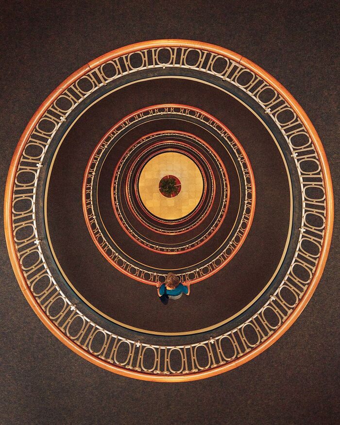 A top-down view of a person standing on a circular staircase, showcasing architectural locations.