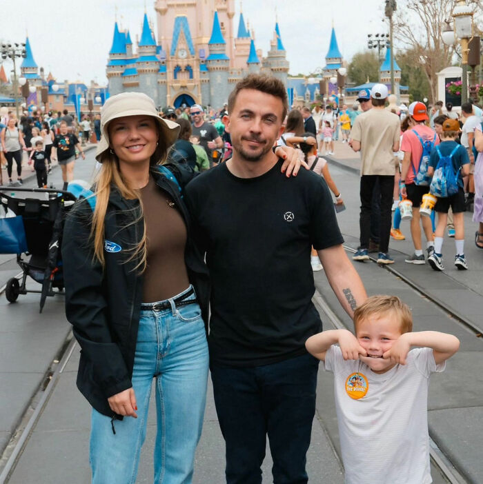 Malcom in the Middle star Frankie Muniz, his wife Paige, and their child at a theme park.