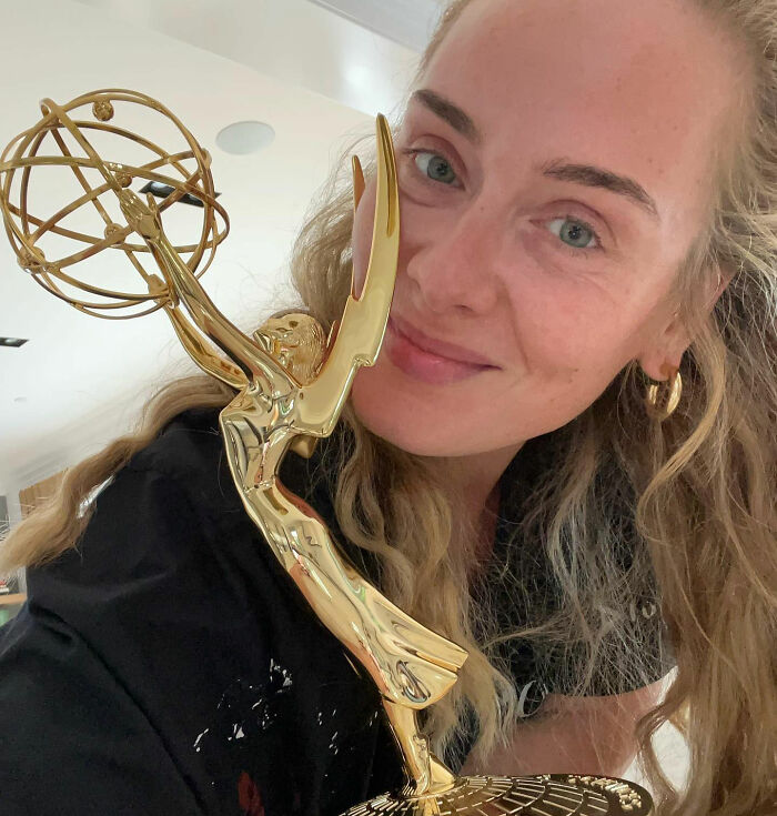 Adele holding an Emmy award, a rare public outing for the singer, sparking discussions. Adele holding an Emmy award, a rare public outing for the singer, sparking discussions.