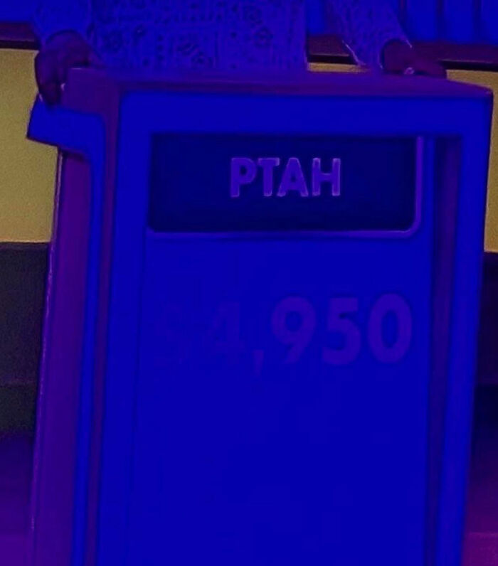 A brightly lit game show podium displaying the name PTAH, representing unique parents' names.