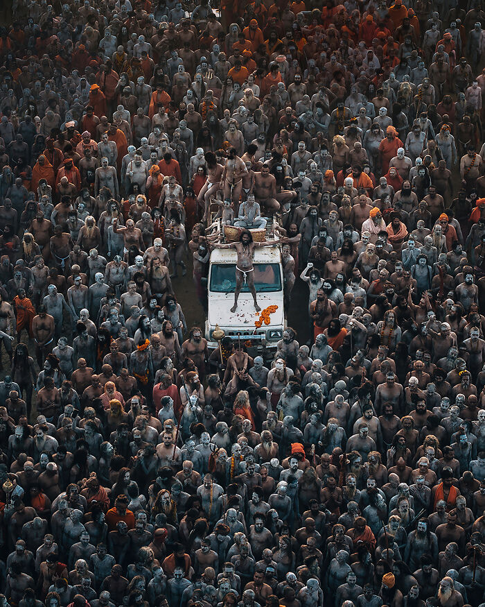 Spectacular Aerial Photographer of the Year photo capturing a dense crowd surrounding a vehicle in a ceremonial setting.