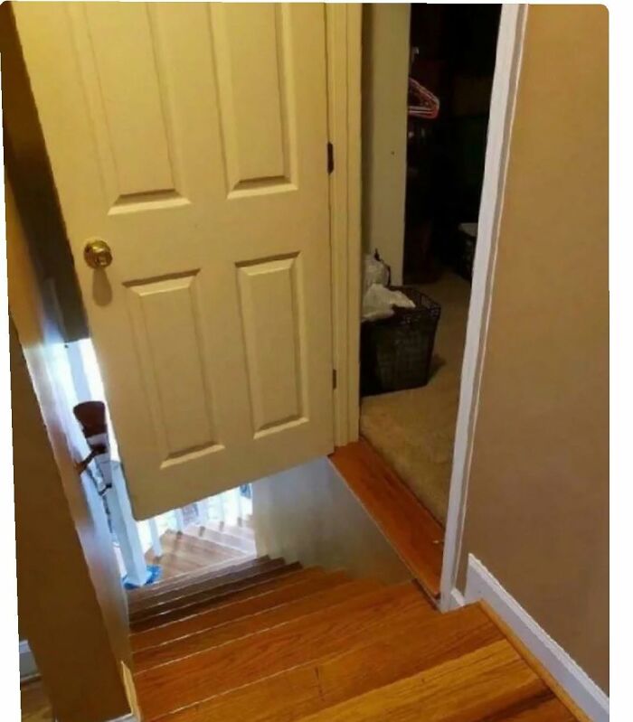 A partially open door at the top of a staircase, an image highlighting America's cultural decline into idiocy.