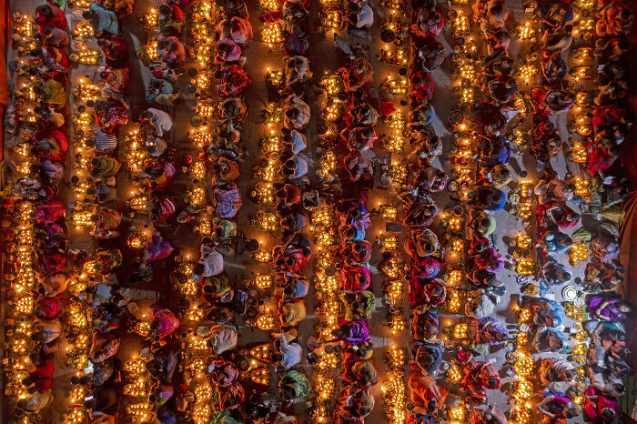 Crowds with glowing lanterns, an aerial photographer award photo capturing a unique festival.