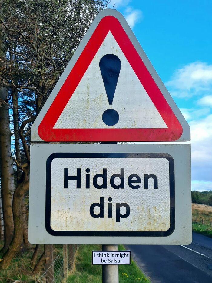 Absurd signs: A brilliant artist created a road sign warning about a hidden dip with a humorous addition.