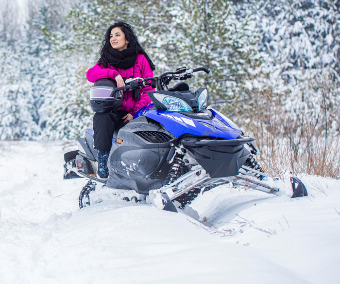 A female guide sitting on a snowmobile, ready to lead an Arctic tour. A female guide sitting on a snowmobile, ready to lead an Arctic tour.