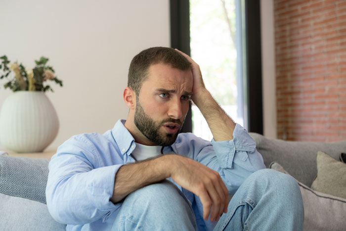 A man looking worried, representing the 39YO BF who is a cheater and worries about his pregnant wife.