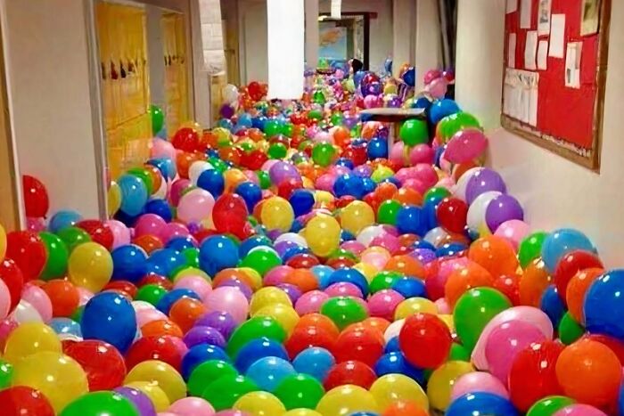Soul-healing post: A hallway filled with colorful balloons, illustrating a professor's lesson on collective happiness.