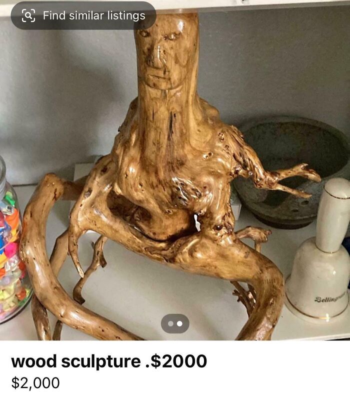 A peculiar wood sculpture of a humanoid figure crafted from a tree root, featured in a unhinged marketplace listing.