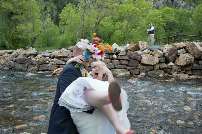 Hilarious photos taken moments before disaster struck: Groom carrying bride across a stream.
