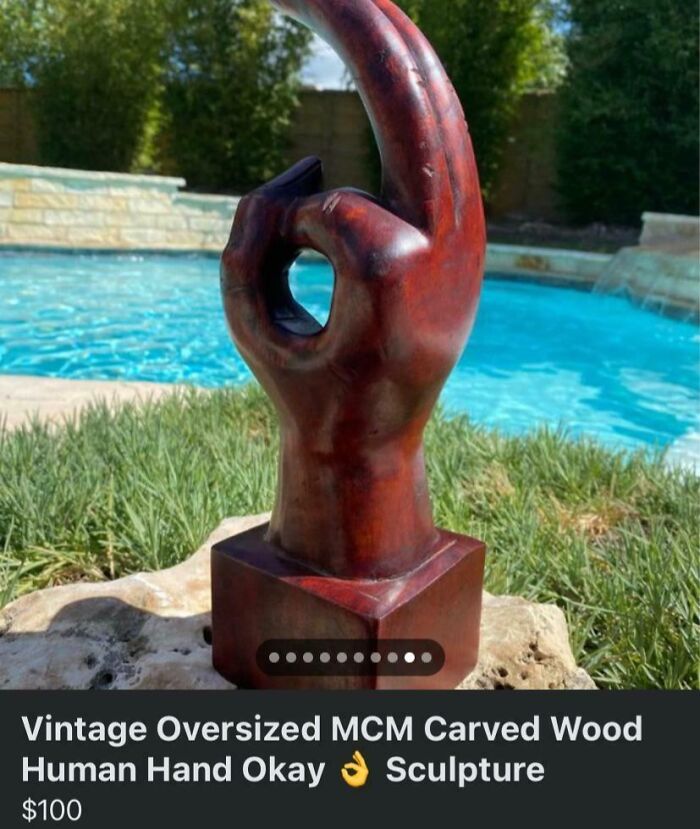 An oversized MCM carved wood human hand making an okay gesture, a quirky marketplace listing.