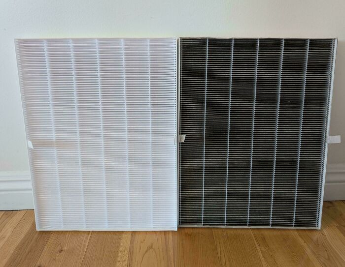 Before-and-after photo of a white, clean air filter next to a dirty, used one, showing changes.