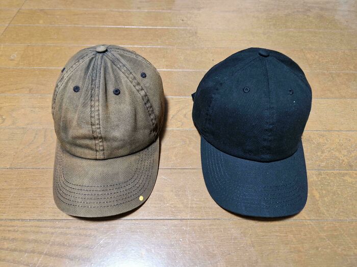Before-and-after photo of two baseball caps, one faded and brown, the other new and black, demonstrating change.