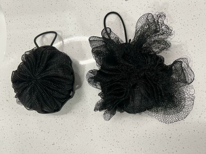 Before-and-after photo of two black shower poufs, one new and compact, the other used and expanded, showing change.