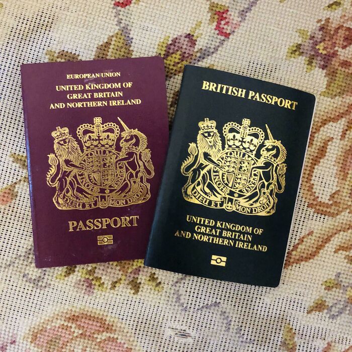 Two British passports, one red from before and a black one from after, illustrating how things can change with new designs.