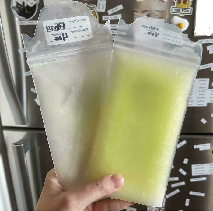 Hand holding two before-and-after bags of breast milk, one white and one slightly green, showing how things can change.