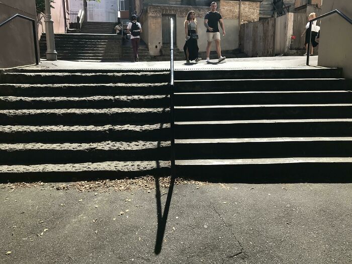Before-and-after photo of stone steps with a clear line of sun and shadow, showing how things can change.
