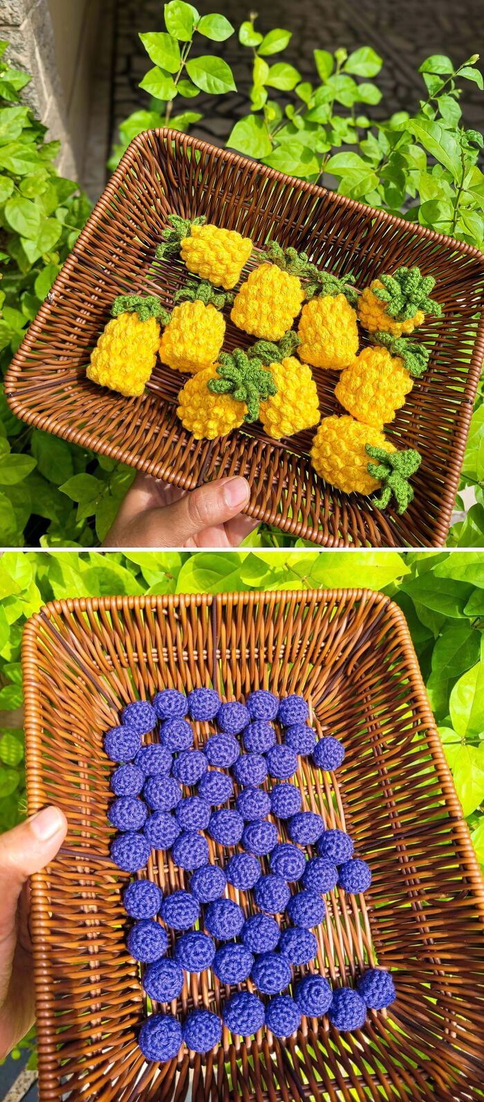 A hand holds a wicker basket filled with small, bright yellow crocheted pineapples, demonstrating the creativity of crochet enthusiasts.