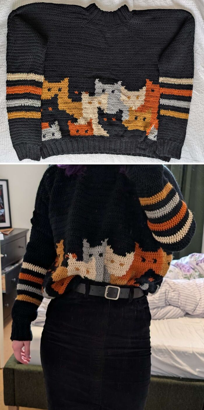 A black crochet sweater featuring an incredible design of cats in various shades of brown, orange, and gray.