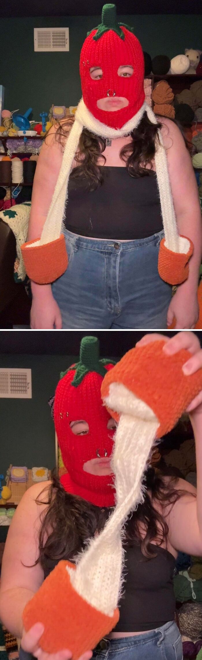 A person wearing a fun, red crochet pepper balaclava with long white and orange sleeves, an incredible crochet creation.