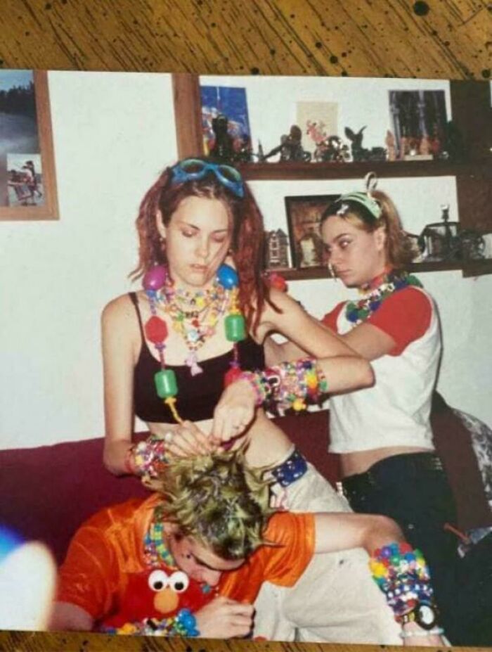 Three 90s kids with neon hair and plastic jewelry, captured in a throwback meme.