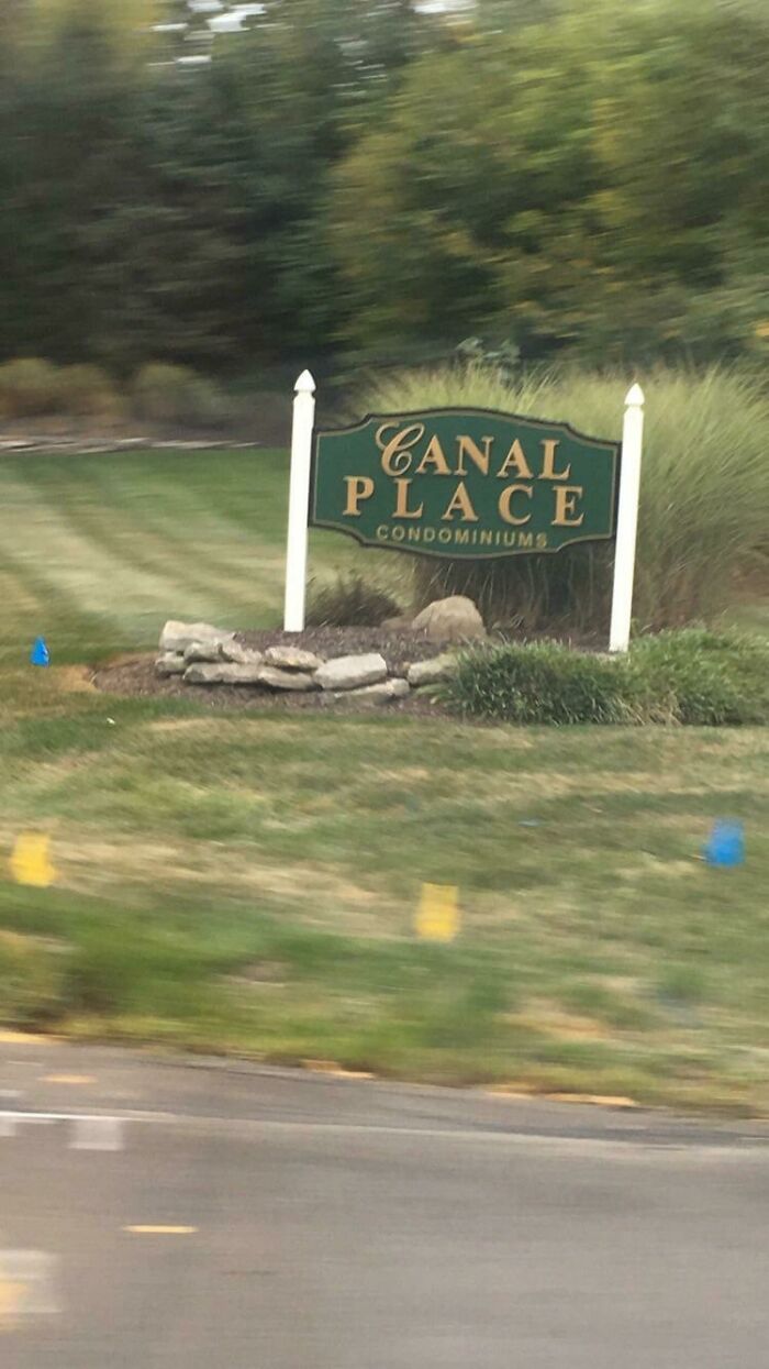 A sign for Canal Place Condominiums with the word Canal oddly spaced, a design fail.