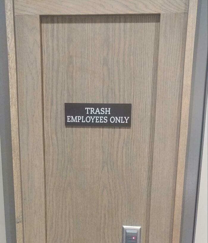 A wooden door with a sign that reads TRASH EMPLOYEES ONLY, an example of designers failing.