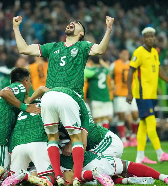 A soccer team celebrates a goal on the field, with one player cheering and others embracing, creating a joyful optical illusion.