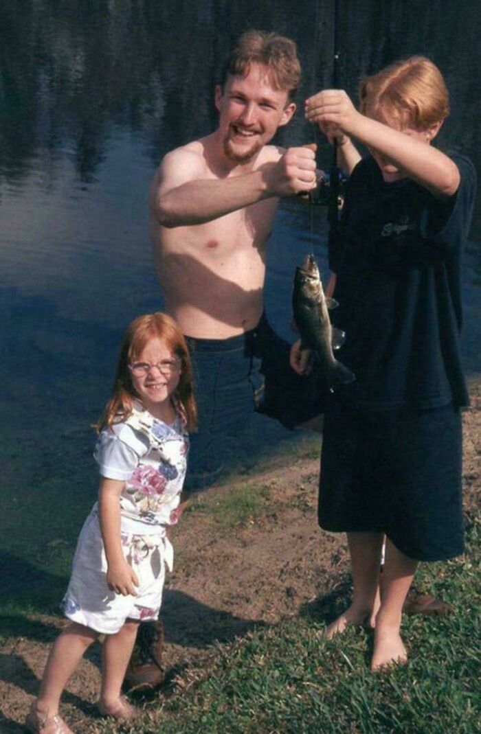 A girl and a man appear to be different heights due to a real life optical illusion of perspective near water.