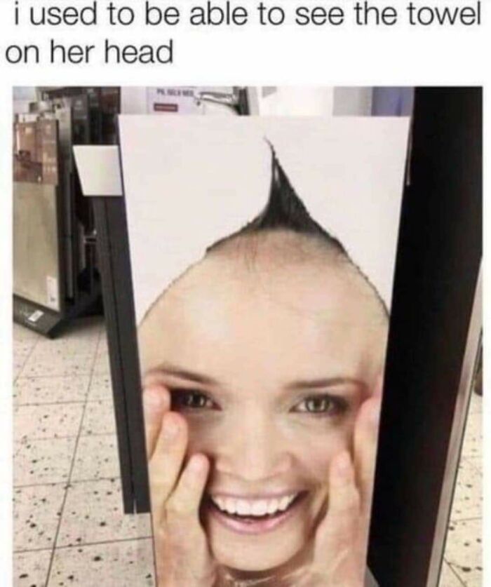 A display stand with a woman's face printed on it, the top part of her head missing. A design fail.