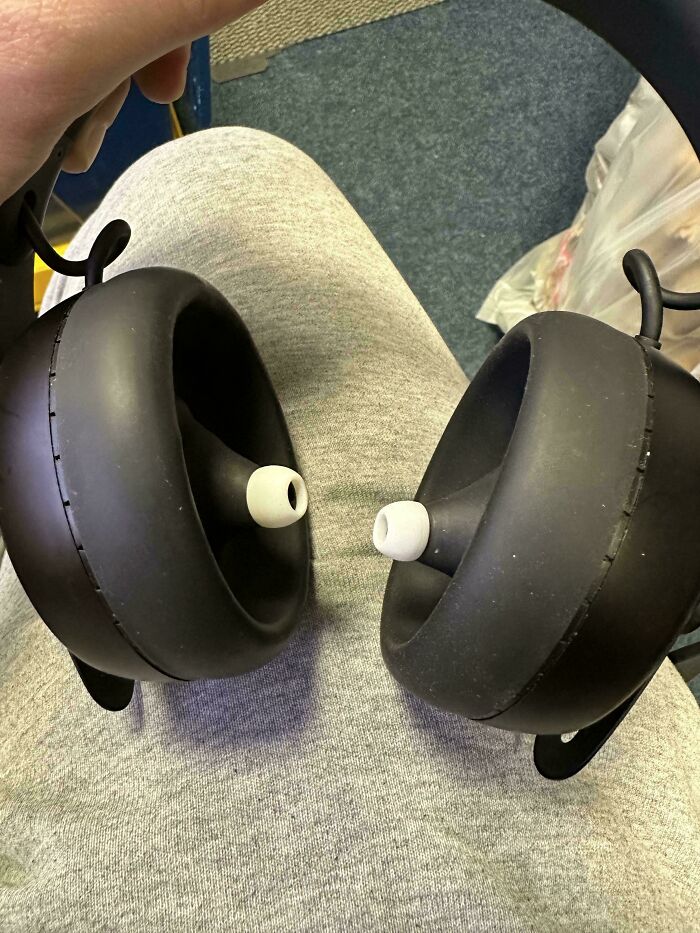 Mismatched headphones with earbuds pointing outward, showcasing designers who failed at their job.