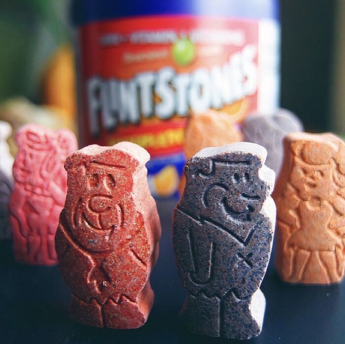 Flintstones vitamins, a throwback for 90s kids, shown in a close-up with the bottle blurred in the background.