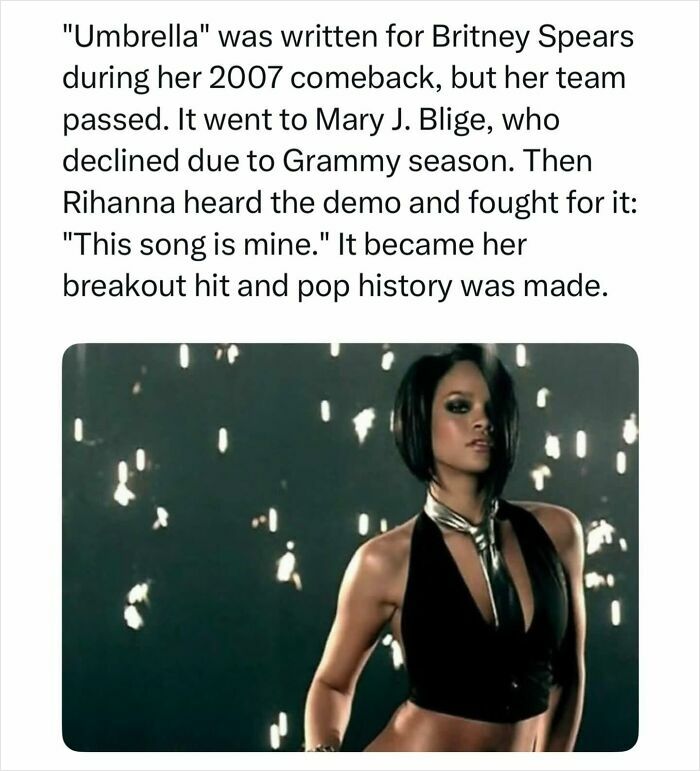 Pop culture post: Rihanna in a black halter top and silver tie, from the music video for her hit song Umbrella.