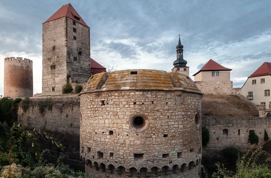 Interesting castles, a historic castle with various stone towers and red-tiled roofs.