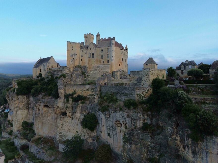 Beautiful castles, a majestic castle built atop a rocky cliff overlooking a valley.