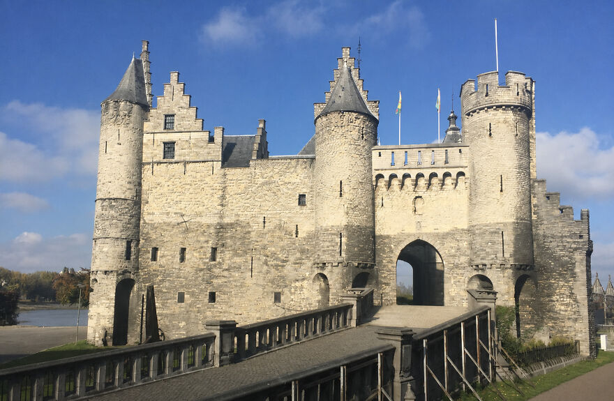 Beautiful castles, a stone castle with multiple turrets and a bridge, under a blue sky.