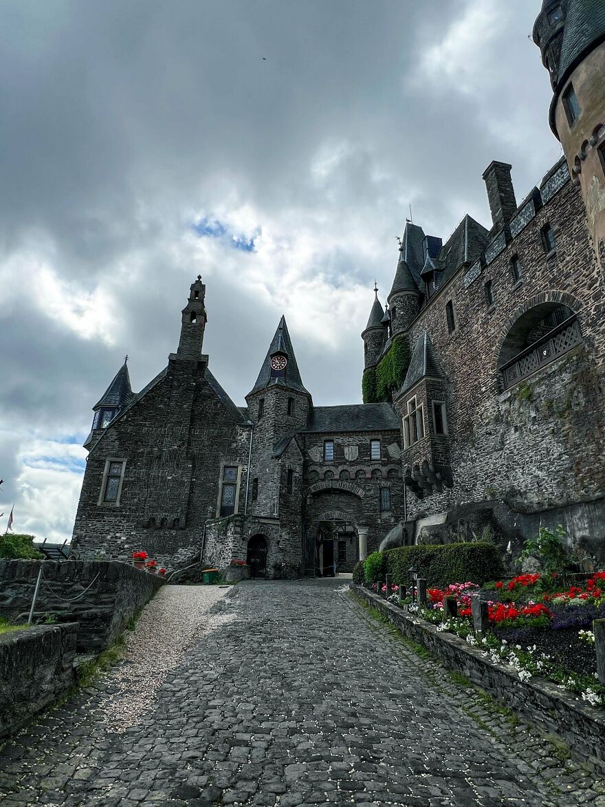 Beautiful stone castle entrance with a cobblestone path, showcasing interesting castles.