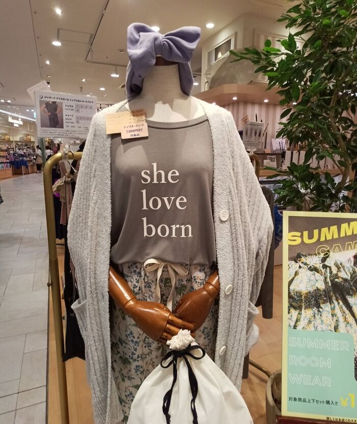 A mannequin in Japan wearing a shirt with the phrase 'she love born,' a hilarious example of getting lost in translation.