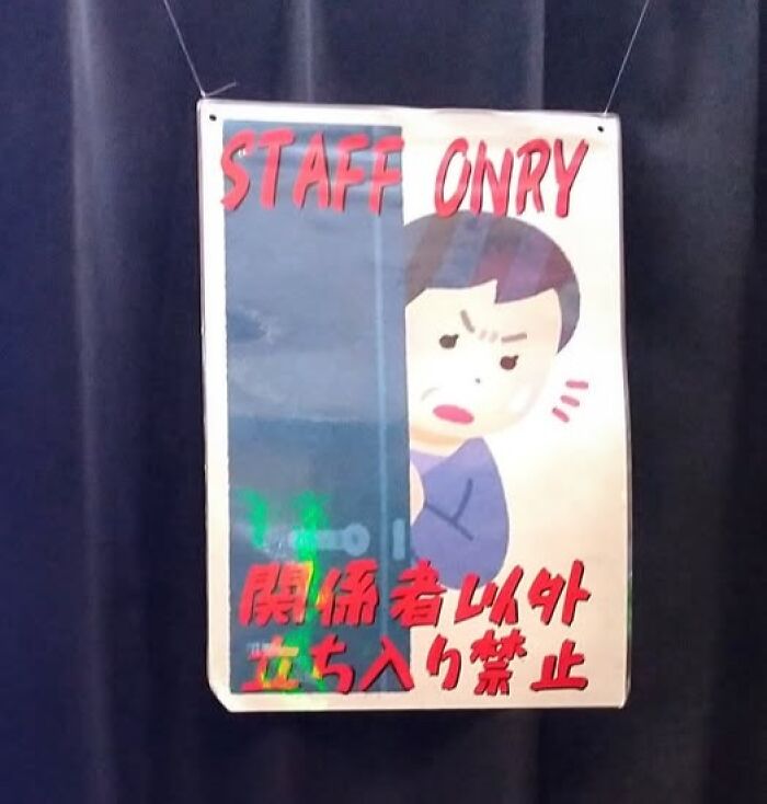 A hand-drawn sign in Japan says 'STAFF ONRY' (only) with an angry cartoon face, an example of getting lost in translation.