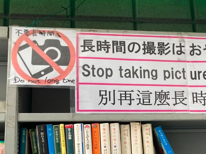 A sign in Japan saying 'Stop taking picture' and 'Do not long time' with a camera crossed out, a hilarious example of lost in translation.