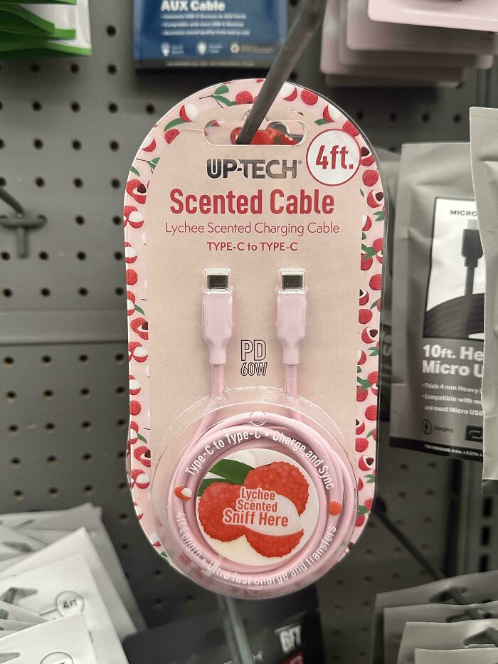 A pink lychee scented charging cable on a store shelf, illustrating an aspect of consumerism and a 400% price difference.