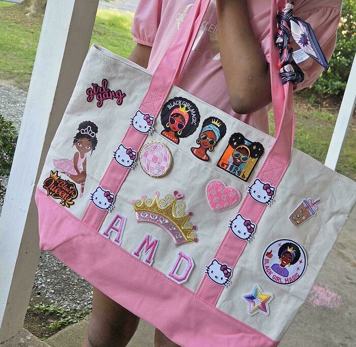 A girl carrying a handmade tote bag adorned with patches and letters, a magical and patient project.